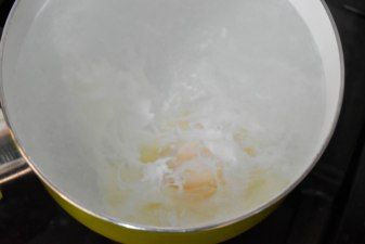 Egg cooking in simmering water